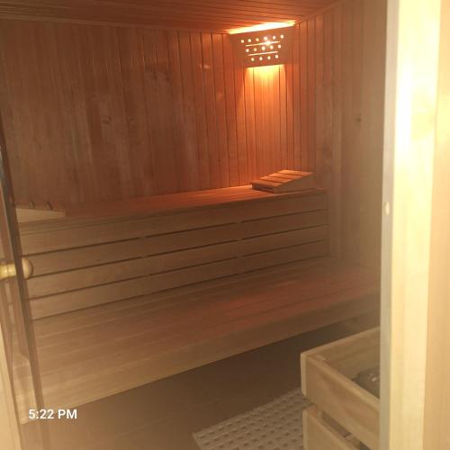 a wooden sauna with a bench in a bathroom at Villa Grenzenlos in Löffingen