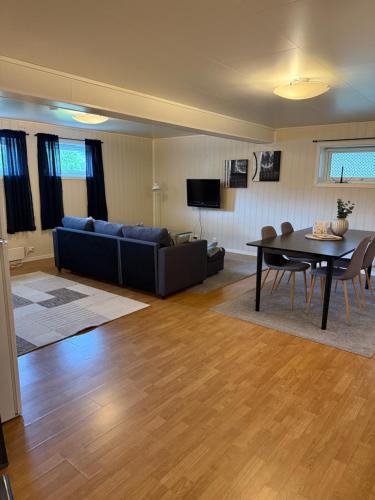 a living room with a couch and a table at Stranda Apartment in Senja