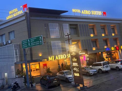 a hotel area with cars parked in front of it at Mj Aero Suite in Dehradun Airport