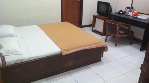 Кровать или кровати в номере Hotel Handayani