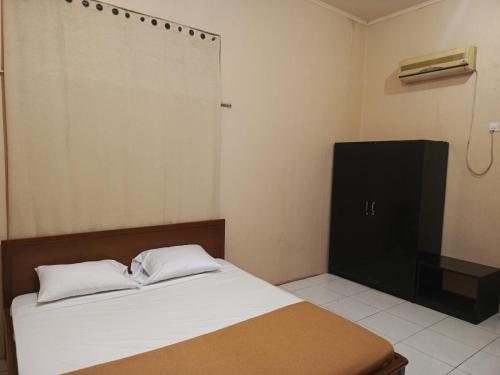 Postel nebo postele na pokoji v ubytování Hotel Handayani