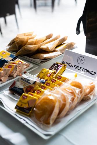 a buffet with hot dogs and chips on a table at Hotel De Nac in Nago-Torbole