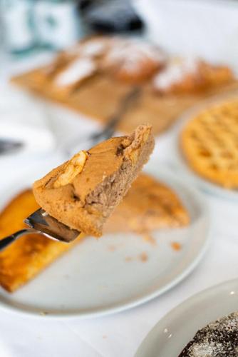 a piece of pie on a fork on a plate at Hotel De Nac in Nago-Torbole