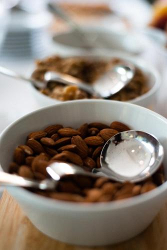 a bowl of almonds and spoons on a table at Hotel De Nac in Nago-Torbole