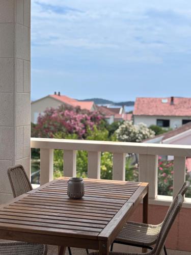 a wooden table on a balcony with a cup on it at Villa Lulu in Orebić
