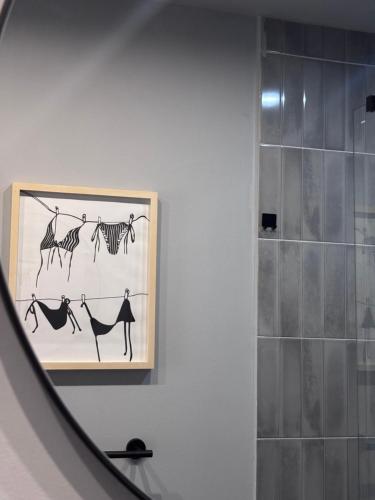 a bathroom with a picture of animals on the wall at Villa Lulu in Orebić