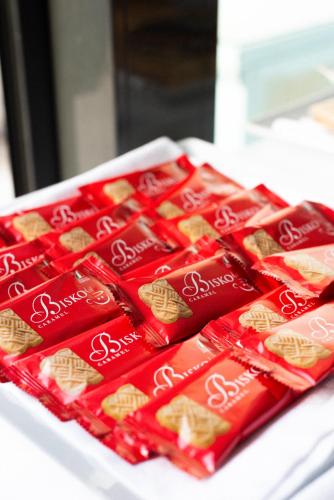 a group of red packets ofsnacks on a table at Hotel De Nac in Nago-Torbole