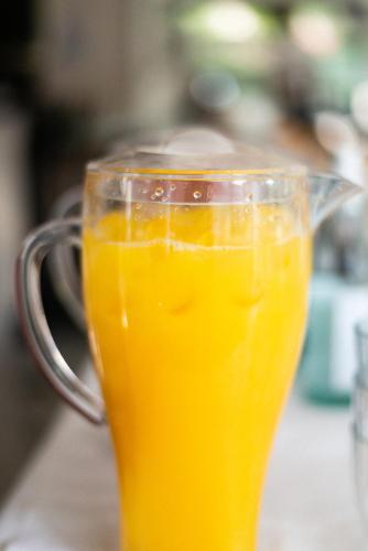 a glass mug filled with orange juice on a table at Hotel De Nac in Nago-Torbole