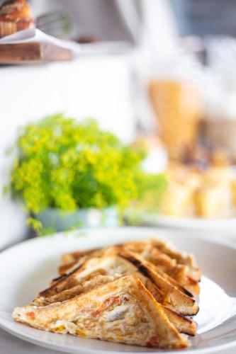 a white plate with a piece of toast on it at Eagle View Lodge - Kigali in Kigali