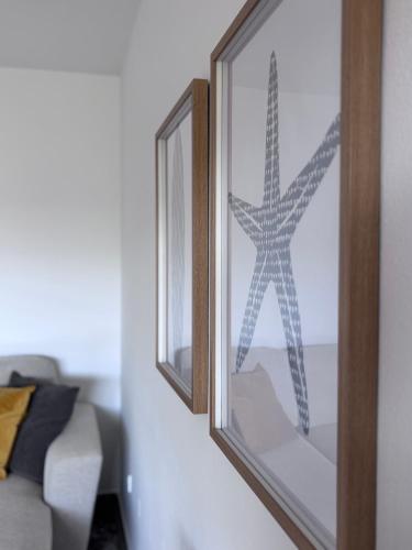 two mirrors on a wall in a living room at Villa Lulu in Orebić