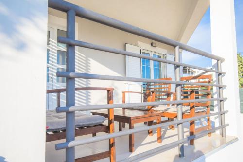 a balcony with orange chairs and a blue railing at House Matilda in Primošten