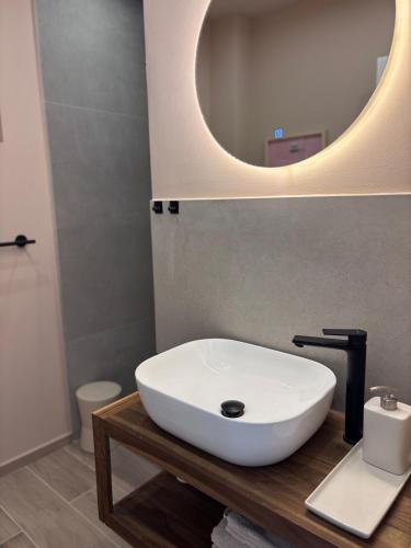a bathroom with a white sink and a mirror at Villa Lulu in Orebić
