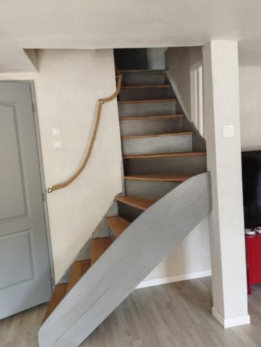 a staircase leading up to the second floor of a house at les filatures in Saint-Vincent-de-Reins