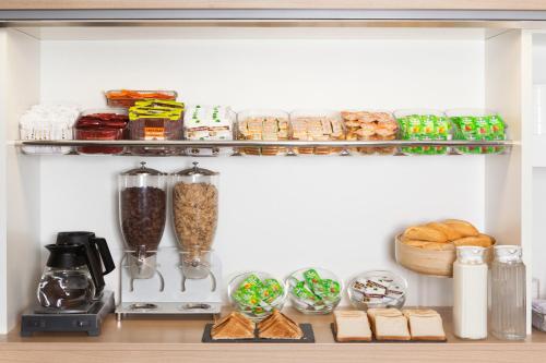a kitchen pantry with food items on a shelf at hotelF1 Besancon Ouest Micropolis in Besançon
