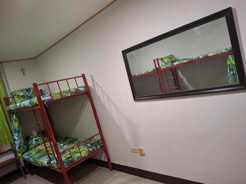 a room with two bunk beds and a mirror at Room for rent - SMR in Cebu City