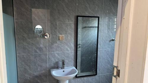 a bathroom with a shower with a sink and a toilet at Serene Oasis in Lagos - Private Pool Relaxing Ambiance in Lagos