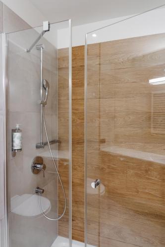 a shower with a glass door in a bathroom at Hotel Shuum Boutique - Destigo Hotels in Kołobrzeg