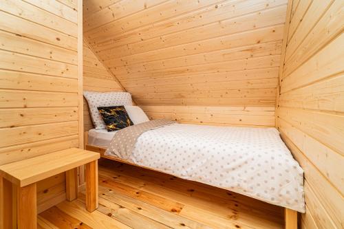 a small wooden room with a bed in a sauna at Perła Kaszub in Wiele