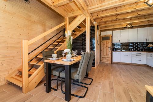 a kitchen and dining room with a table and chairs at Perła Kaszub in Wiele