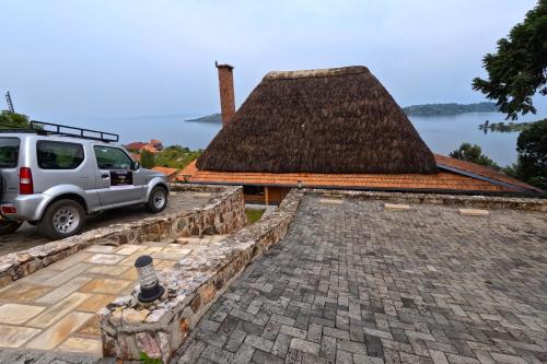 a white suv parked on the roof of a building at Umutuzo Lodge Kivu Lake in Buhoro