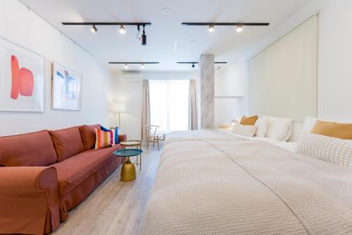 a living room with a couch and a table at Jasmine Style Akasaka in Tokyo