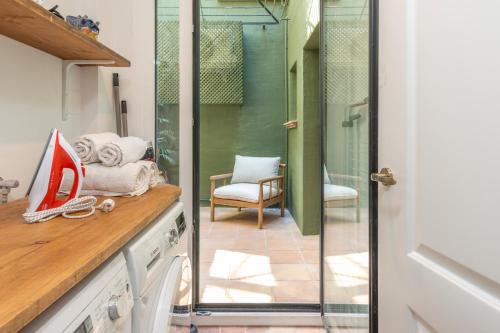 a kitchen with a glass door leading to a patio at La Casa del Faro de Llafranc in Llafranc