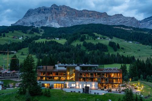 a building on a hill with mountains in the background at Badia Hill in Badia