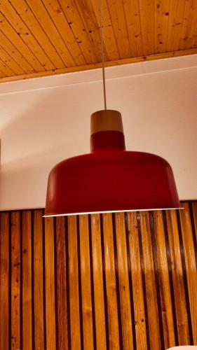 a red light fixture hanging from a ceiling at Casa do Lambril in Tinalhas