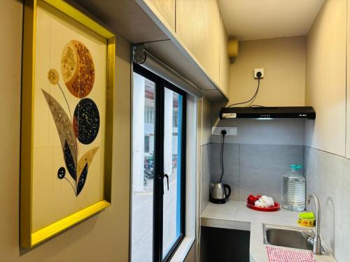 a small kitchen with a sink and a window at Stylish, Modern Room with City View, Oasis in Melaka