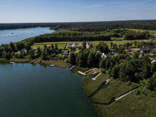 an aerial view of a village on the shore of a lake at Perła Kaszub in Wiele
