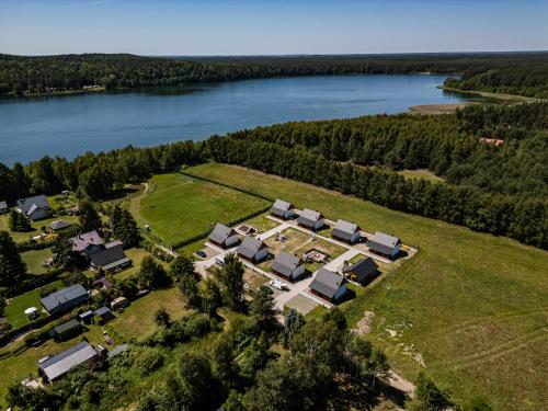 an aerial view of a house next to a lake at Perła Kaszub in Wiele