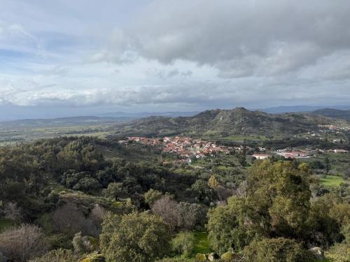 a view of a town in a valley with a mountain at Casa do Lambril in Tinalhas