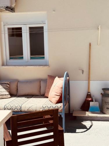 a living room with a couch and a window at Casa do Lambril in Tinalhas