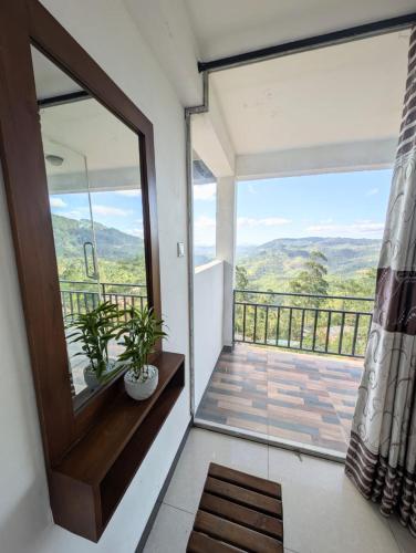 a room with a large glass door and a balcony at White Lotus Haputale in Haputale