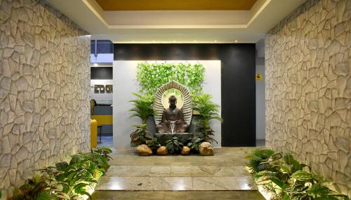 a lobby with a statue of a woman in a fountain at The Edge in Chennai