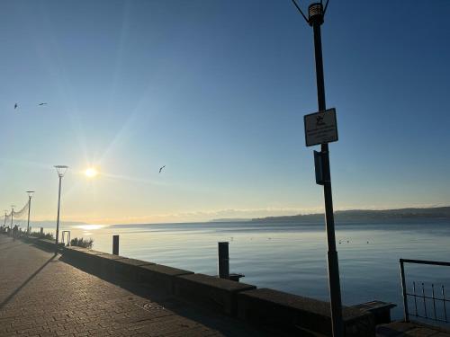 a street light next to a body of water at Hotel Capri in Überlingen