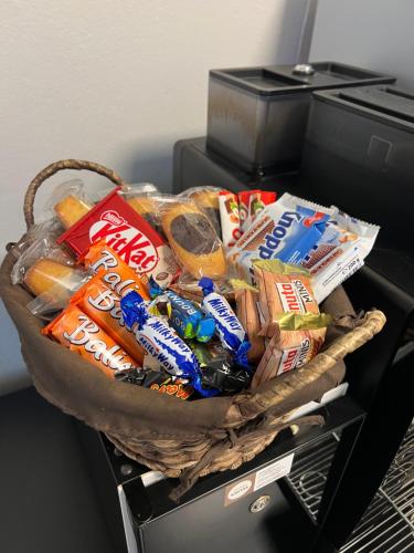 a basket of food and drinks on top of a refrigerator at Hotel Capri in Überlingen
