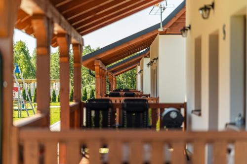 a porch with a table and chairs on it at Perła Kaszub in Wiele
