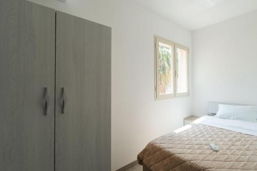 a bedroom with a bed and a window at Lu Pinninu in Novoli