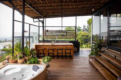 a large room with a bath tub and a table at Eagle View Lodge - Kigali in Kigali