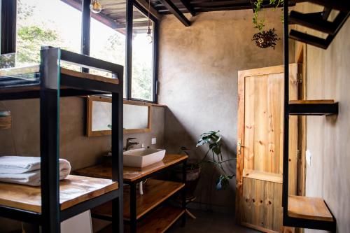 a bathroom with a sink and a bunk bed at Eagle View Lodge - Kigali in Kigali