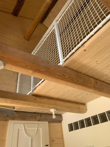 a wooden ceiling with a bird cage on it at Cabin Valle Cervo 