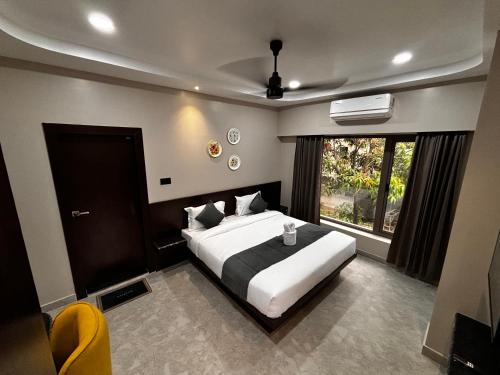 a bedroom with a large bed and a window at Park Abode Boutique Guest House in Guwahati