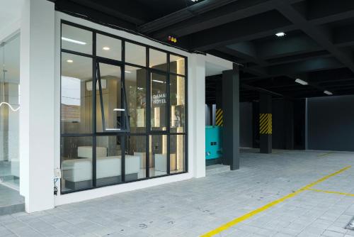 an empty building with a glass door with chairs in it at Sans Vibes Hotel Damai Yogyakarta in Kejayan