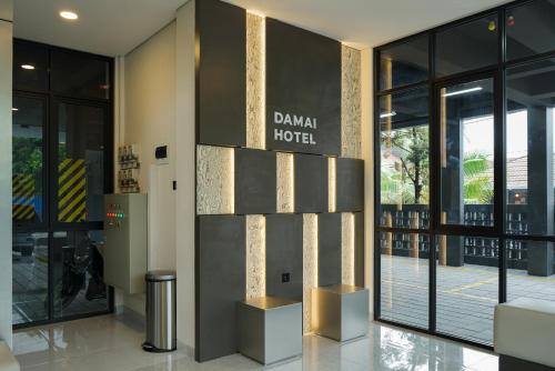 a building with a sign that reads danish hotel at Sans Vibes Hotel Damai Yogyakarta in Kejayan