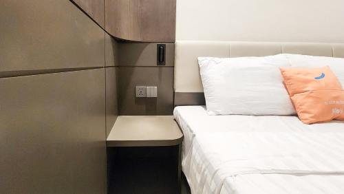 a small room with a bed and a pillow at Sans Vibes Hotel Damai Yogyakarta in Kejayan
