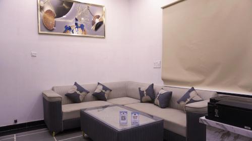 a living room with a couch and a table at Sagar Villa Udaipur in Udaipur