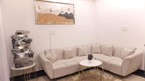 a living room with a couch and two tables at Sagar Villa Udaipur in Udaipur