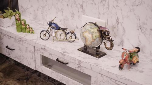 a white marble counter with figurines and a globe on it at Sagar Villa Udaipur in Udaipur