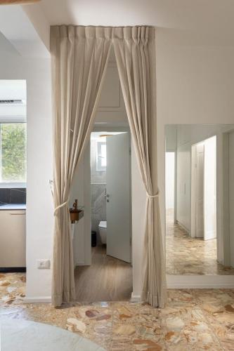a room with a curtain and a bathroom with a toilet at The charm of Jerusalem in Jerusalem
